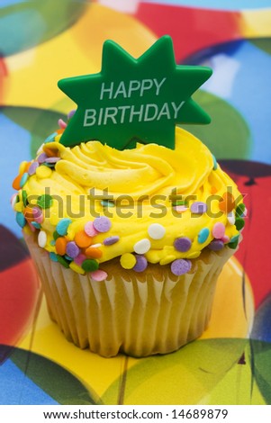 Birthday cupcake with balloon background with happy birthday sign