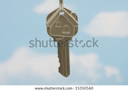 House key on keychain on a blue background
