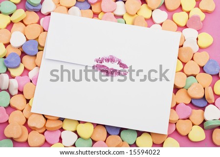 Envelope with lipstick lip prints on a heart background
