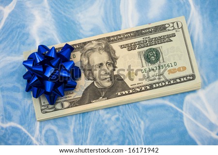 Twenty dollar bills with red bow on them on blue background, gift of money