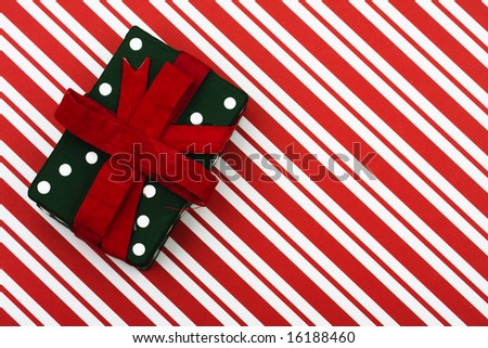 Green and red present on red striped background