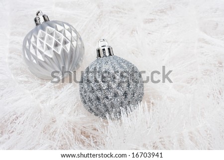 Silver glass balls on white garland background, Christmas background