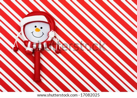 Snowman on a red striped background with copy space