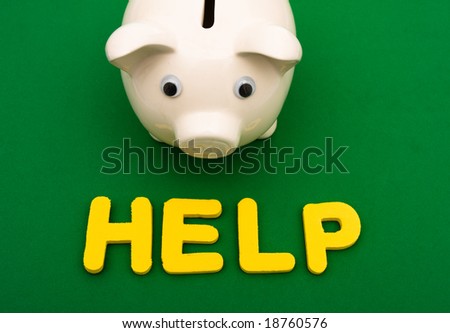 Piggy bank with the word help on green background, financial help