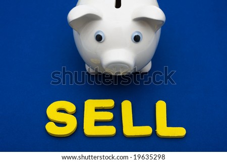 Piggy bank with letters spelling sell on blue background, investing your savings