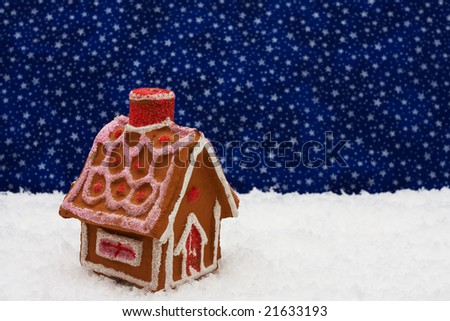 Gingerbread house on snow with star background, gingerbread house