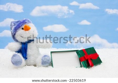 Gift card sitting with a snowman on sky background, gift card