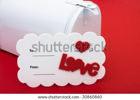 A white postcard with a red heart and the word love on a red background, love postcard