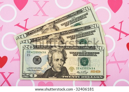 Three twenty dollar bills on a pink love background, the love of money