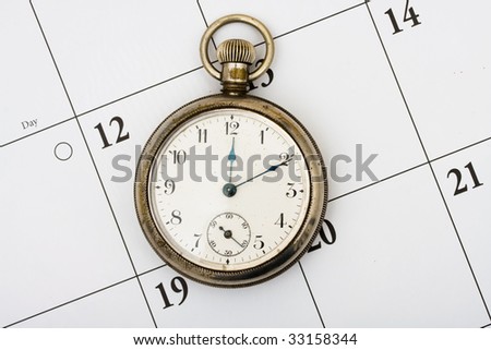 A pocket watch sitting on a calendar background, time management