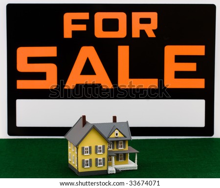 A model house and a for sale sign on a sky background, House for sale