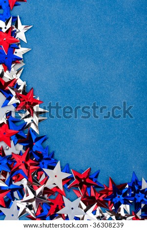 Close up of shiny gold stars making a border on a blue background, multi coloured star background
