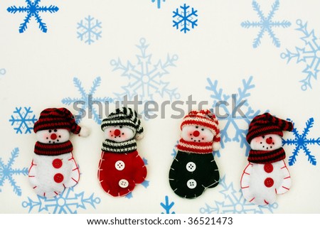 Four snowman  mittens sitting together on a snowflake background, happy holidays