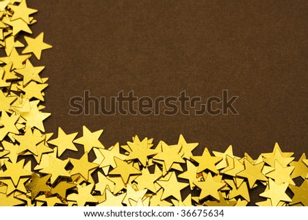 Gold stars making a border on a brown background, gold star border