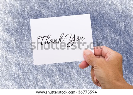 A hand holding a thank you card on a blue background, thank you card
