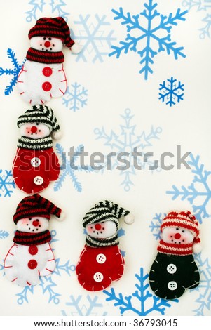 Snowman  mittens sitting together on a snowflake background, happy holidays