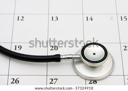 A stethoscope sitting on a calendar background, doctors appointment