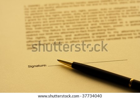 A piece of paper with the word signature and a pen, signing a contract
