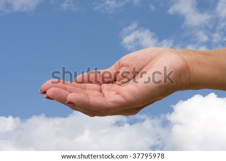 A hand ready to hold something on a sky background, holding hands