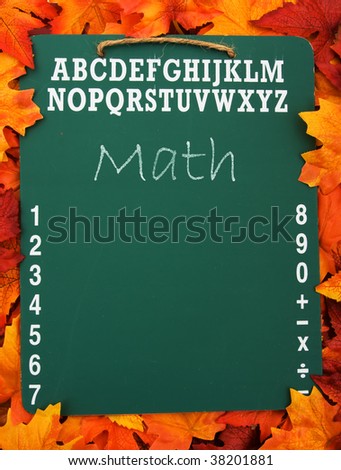 A green chalk board with the word math on a fall leaf background, education
