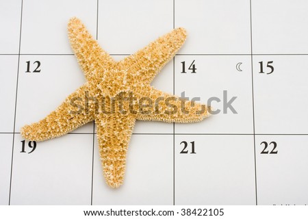 A starfish sitting on a calendar, vacation date