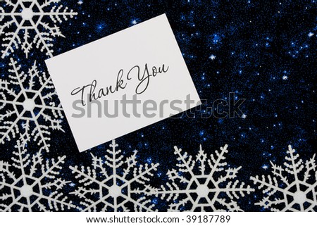 Snowflakes with a thank you card on a blue background, snowflake background