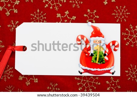 A blank gift tag with Santa Claus on a red snowflake background, Christmas gifts