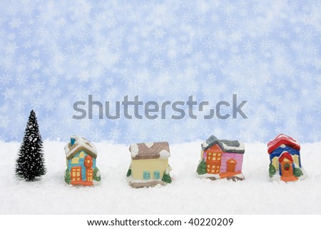 A Christmas village sitting on a blue snowflake background, Christmas village