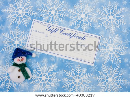Snowflakes with a blank gift certificate and a snowman on a blue background, snowflake background