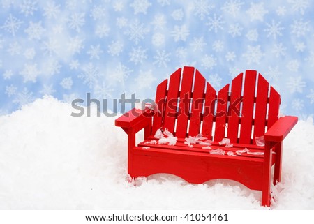 A red chair sitting on snow with a snowflake background, happy holidays