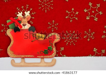 Santas sleigh with a reindeer inside and a white ribbon border on a red background