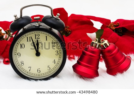 An old fashioned clock with poinsettia flowers on a white background