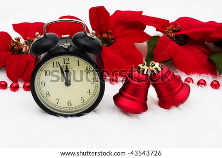 An old fashioned clock with poinsettia flowers on a white background