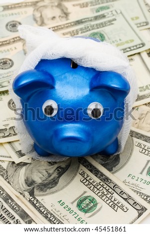 Piggy bank with a bandage over it on a money background, medication costs