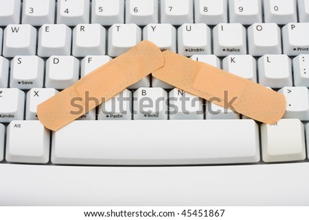 Two bandages on a computer keyboard, online medical advice