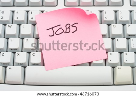 A pink sticky note saying jobs sitting on a computer keyboard, Apply for jobs online