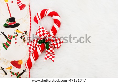 A candy cane with a ribbon border on a white background
