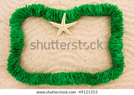 A green lei making a border on a sand background, Summer fun holiday border