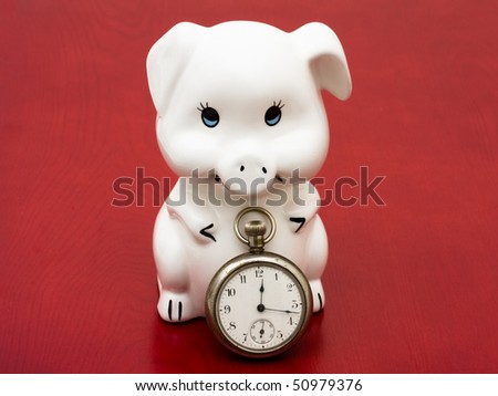A piggy bank with a retro watch on a red background, savings time