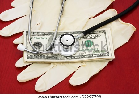 A stethoscope with money on a wooden background, Medical Costs