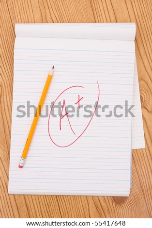 A pencil on a piece of paper with a grade on it, good grades