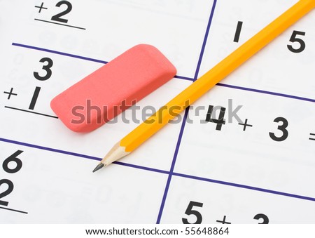  photo : A pencil and an eraser on a math sheet background, math homework