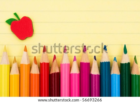 Colorful pencil crayons on a sheet of lined paper, Education background