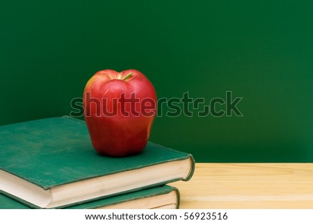 Two old books with an apple in front of the chalkboard, School Days