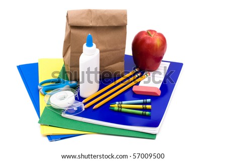 A bunch of school supplies with paper bag lunch, back to school