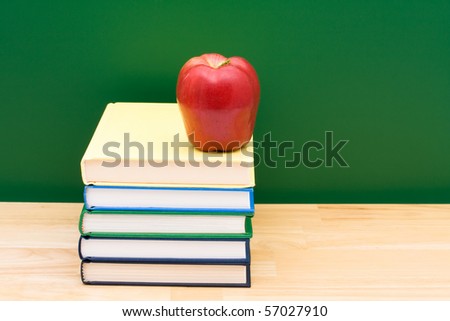 Stack of  books with an apple in front of the chalkboard, School Days
