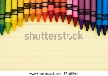 Colorful crayons on a sheet of lined paper, Educational background