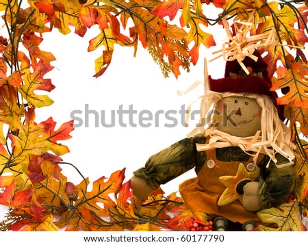 Fall leaves with a scarecrow isolated on white, autumn border