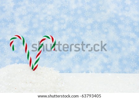 Two green and red candy canes in a snow bank, Winter Scene