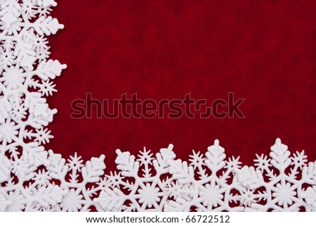 A white snowflake border on a red background, winter time